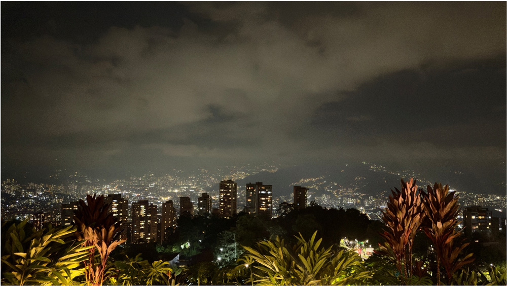 Medellín at night. The city is experiencing increasing land scarcity, especially in its most desirable urban zones like El Poblado, Laureles, and Envigado.
